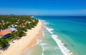 Caribbean islands travel guide featuring coastal landscape with turquoise water, golden sand beach, green hills, and colorful rooftops among palm trees