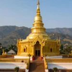 Wat Phra That Doi Suthep golden chedi overlooking misty mountains and Chiang Mai city, northern Thailand
