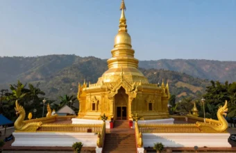 Wat Phra That Doi Suthep golden chedi overlooking misty mountains and Chiang Mai city, northern Thailand