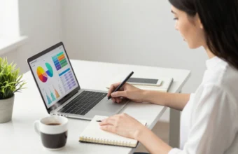 Entrepreneur developing a business plan for six figure business ideas using a laptop and strategy board in a modern home office.